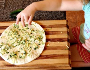 This easy kid-friendly pizza helps use up those zucchinis that are STILL growing in your garden.